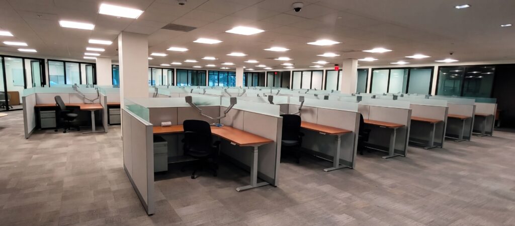 Workstation pod built on remanufactured Steelcase Answer panel systems with new glass stackers, work surfaces, and sit-to-stand bases