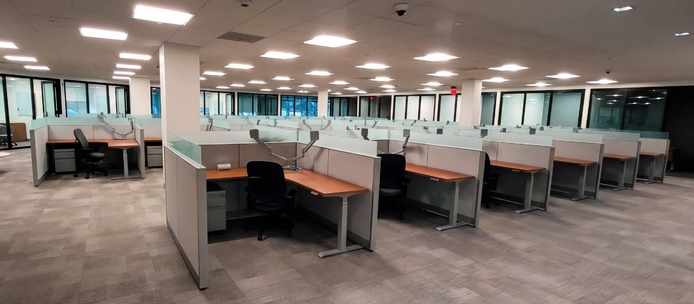 Workstation pod built on remanufactured Steelcase Answer panel systems with new glass stackers, work surfaces, and sit-to-stand bases